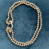 golden pendant combined with a pearl necklace by groen and boothman design
