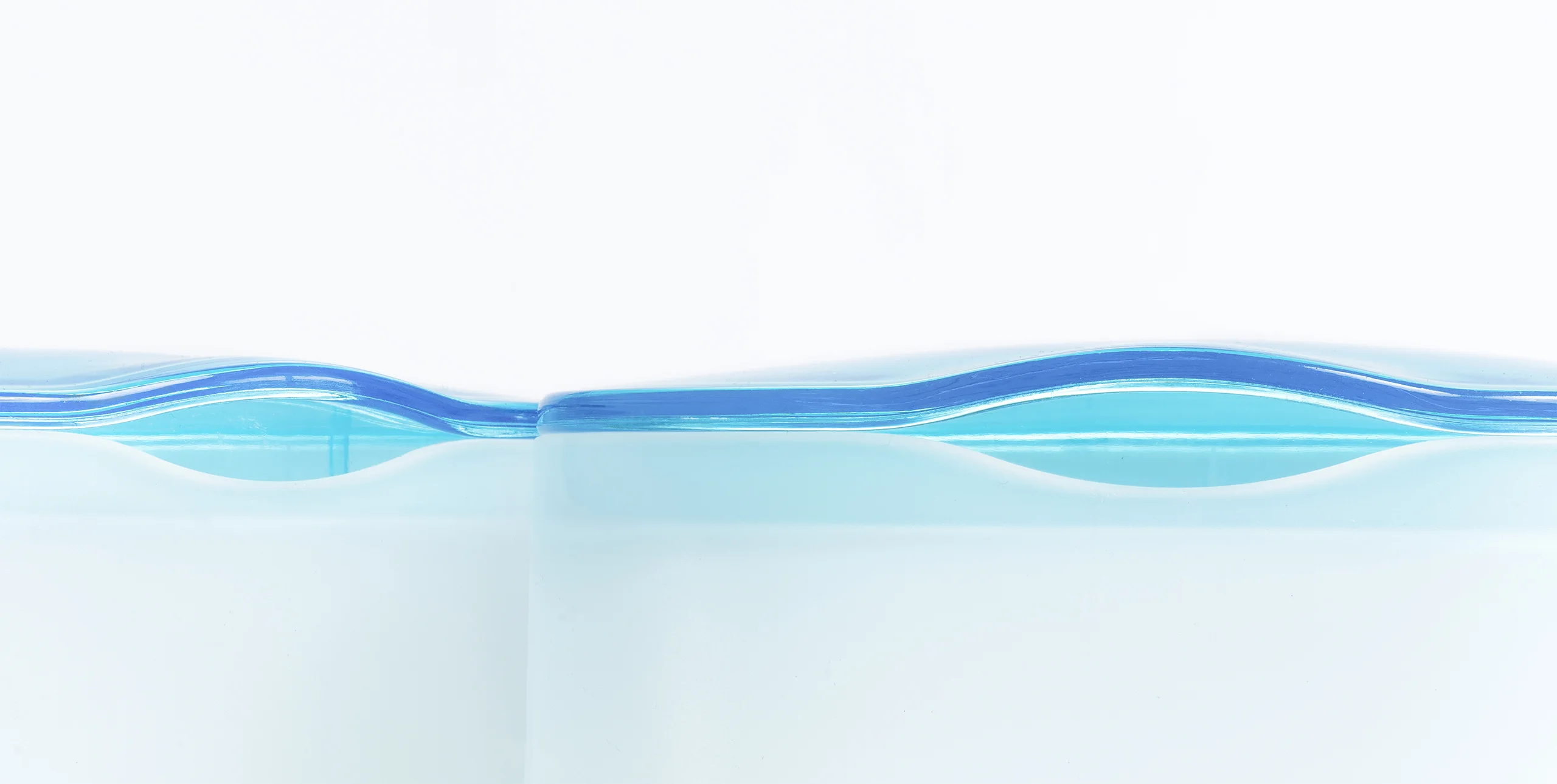 Detail of transparent aqua and opaque white bathroom accessories designed for HEMA