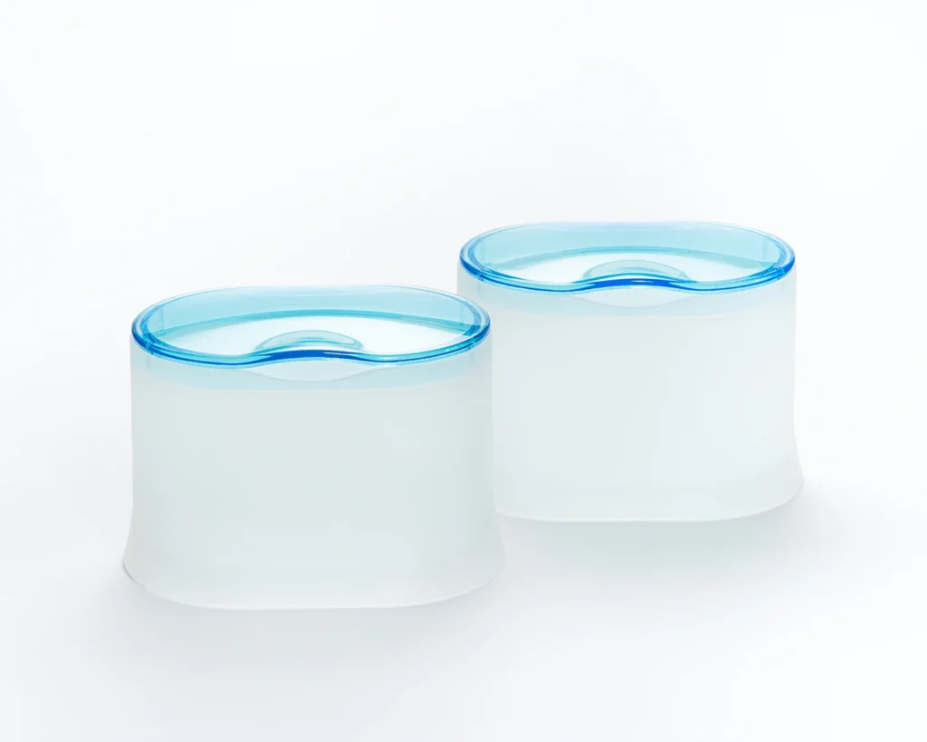HEMA bathroom storage containers with transparent aqua lids and softly diffused white bodies