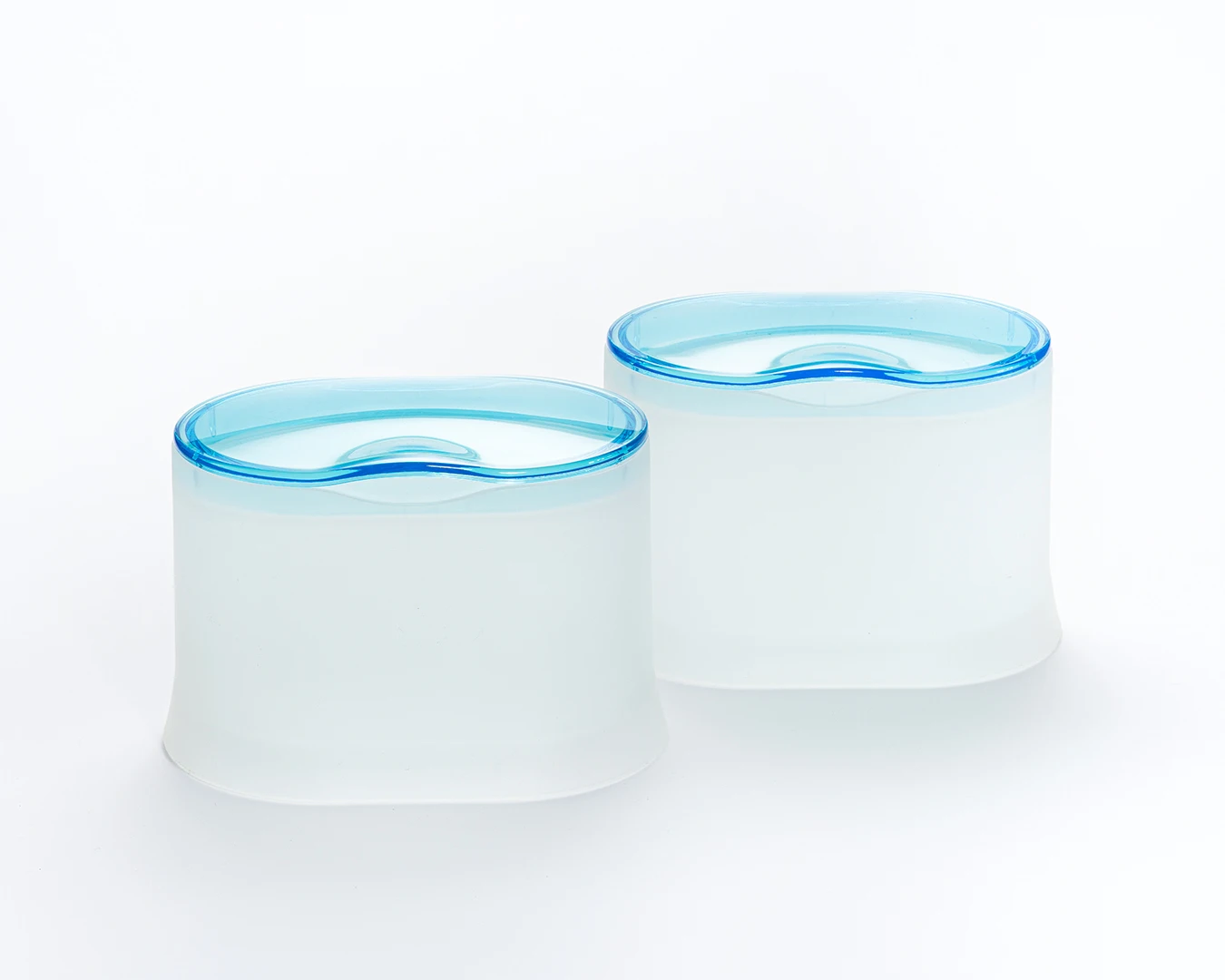HEMA bathroom storage containers with transparent aqua lids and softly diffused white bodies