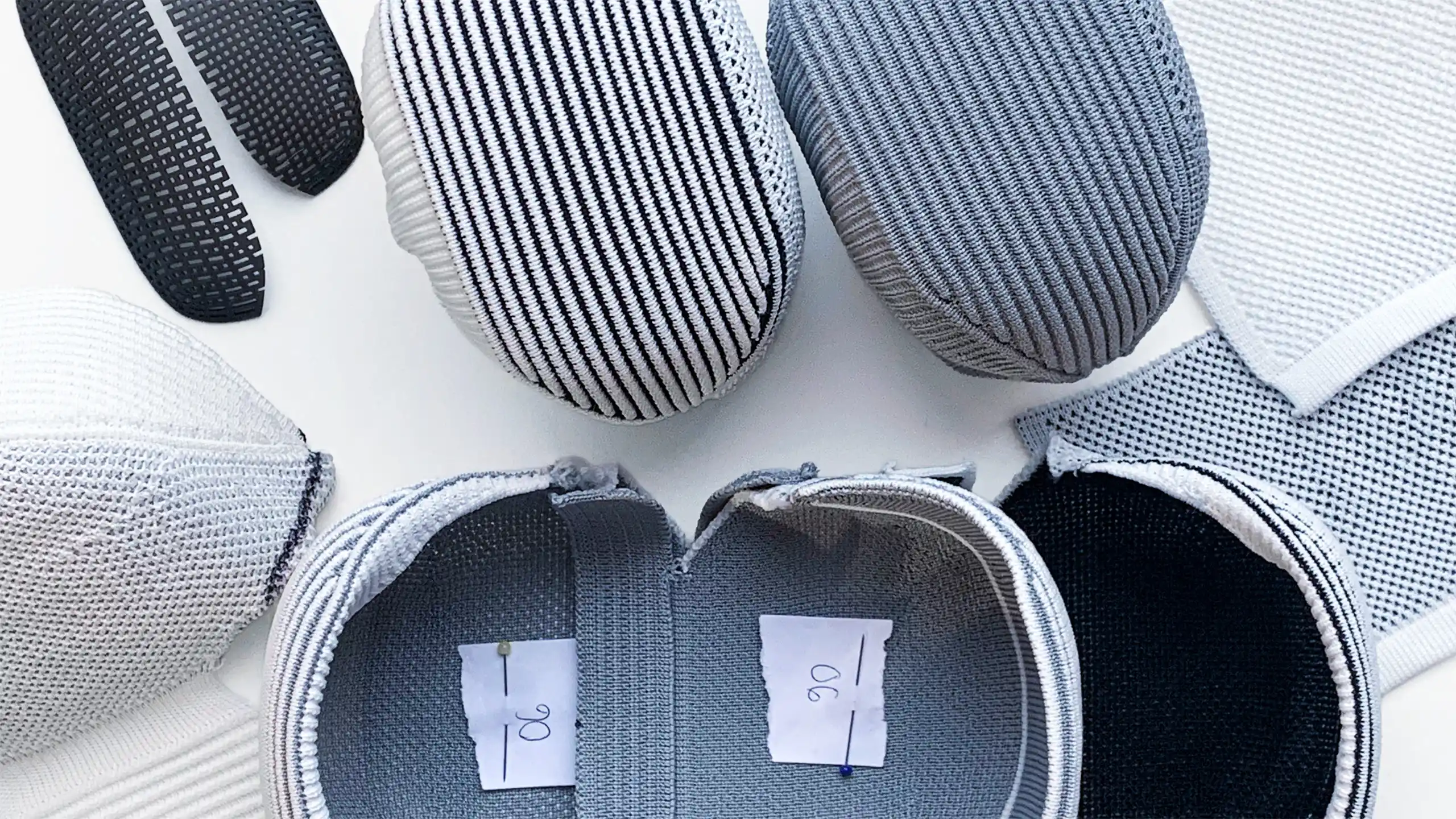 Soft goods development process with knitted watch pouch prototypes and material samples