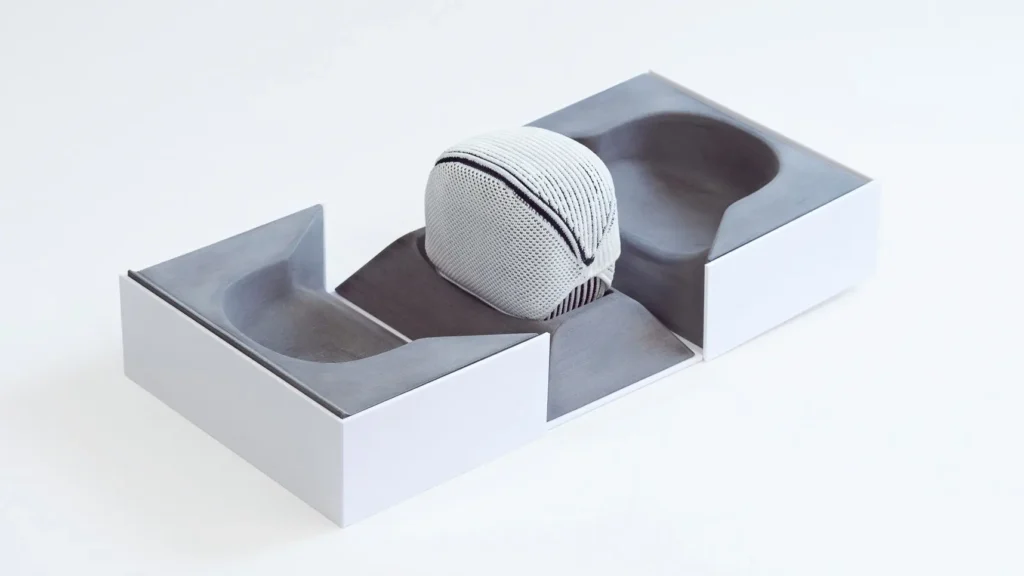 Knitted watch pouch prototype integrated into luxury watch packaging