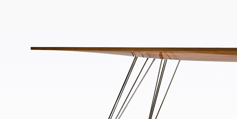 Yacht office table design with slender legs inspired by J-Class sailing yachts