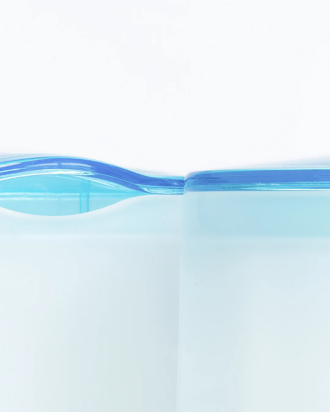 Detail of transparent aqua and opaque white bathroom accessories designed for HEMA
